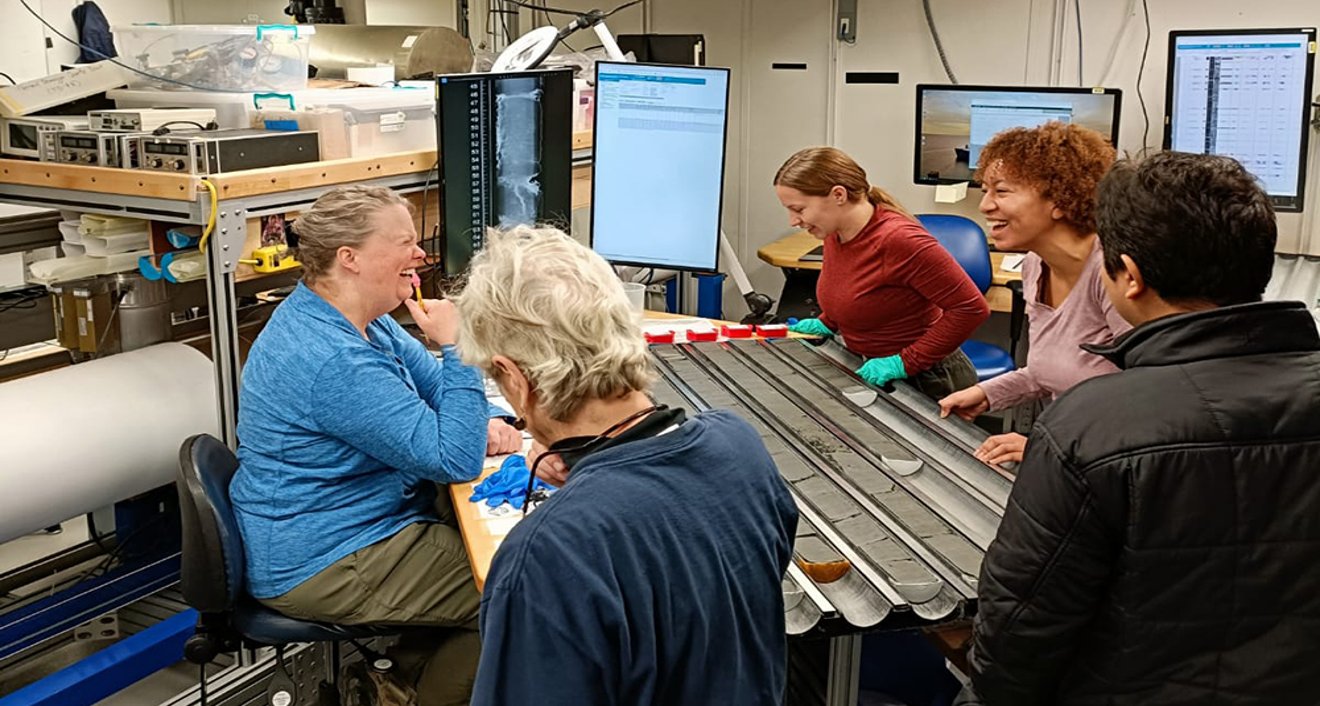Assistant Professor of Earth and Environmental Sciences Raquel Bryant (second-right) laughing with fellow IODP scientists while on the JOIDES Resolution with the International Ocean Discovery Program (IODP). (Courtesy of Raquel Bryant)