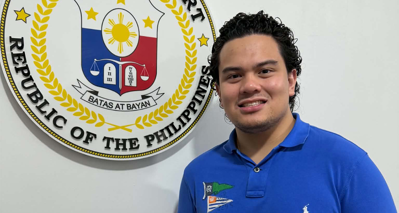 Aaron Arthur Lim '27 near the seal for the Supreme Court in the Phillipines